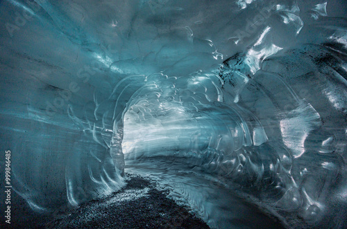 the blue tunnel of Katla Ice Cave, with wave-like semi transparent ice wall, Vík, South Iceland