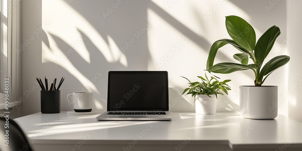 A minimalist workspace with a office desk, a modern laptop, a potted plant A minimalist workspace with a office desk, a modern laptop, a potted plant