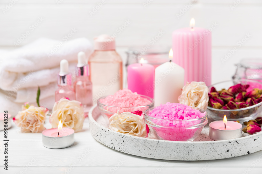 Sea salt for bath with aroma and rose flowers on textured wooden background. Pink sea salt. Spa treatments. Natural salt with herbs and essential oils. skincare concept. Meso for text. Copy space Sea salt for bath with aroma and rose flowers on textured wooden background. Pink sea salt. Spa treatments. Natural salt with herbs and essential oils. skincare concept. Meso for text. Copy space