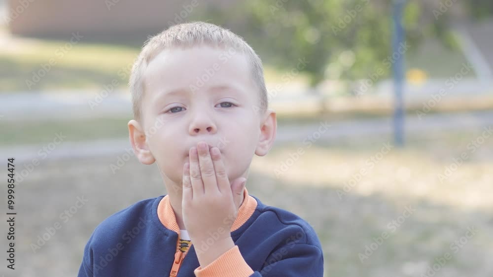 Beautiful lonely little boy blowing a kiss, close up Beautiful lonely little boy blowing a kiss, close up