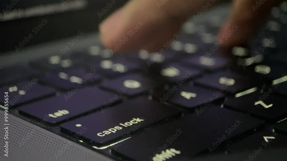 Close-up of finger pressing a key on a black laptop keyboard. Close-up of finger pressing a key on a black laptop keyboard.