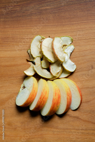 Nature's Delight: Fresh apples and Dried Apple Chips on a Rustic Wooden Board