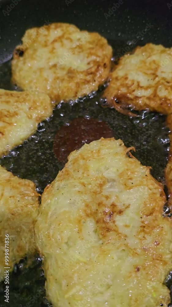 Zucchini pancakes. The process of cooking at home. A frying pan with butter and pancakes on the fire. Zucchini pancakes. The process of cooking at home. A frying pan with butter and pancakes on the fire.