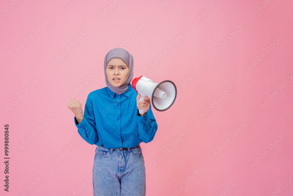 A young woman is passionately speaking with a bright megaphone against a vibrant pink backdrop A young woman is passionately speaking with a bright megaphone against a vibrant pink backdrop