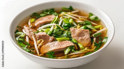 A close-up shot of pork noodle soup with tender slices of pork, bean sprouts, and green onions in a clear broth, served on a plain white background.