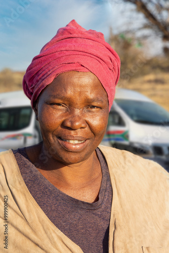 Fotografi village, portrait of single african woman, waiting in the taxi rank station stop