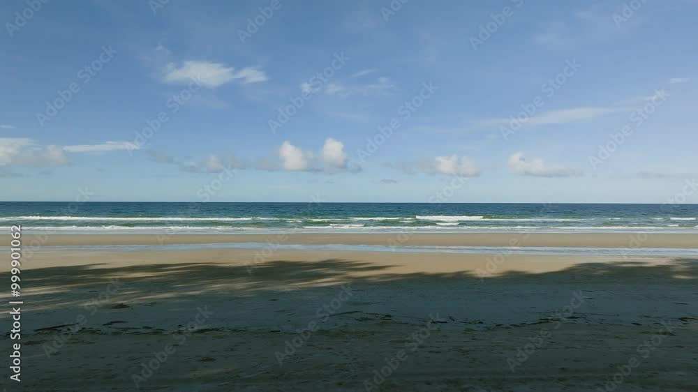 Relaxing Waves and Clear Skies at a Serene Beach During the Afternoon in a Tropical Paradise Relaxing Waves and Clear Skies at a Serene Beach During the Afternoon in a Tropical Paradise
