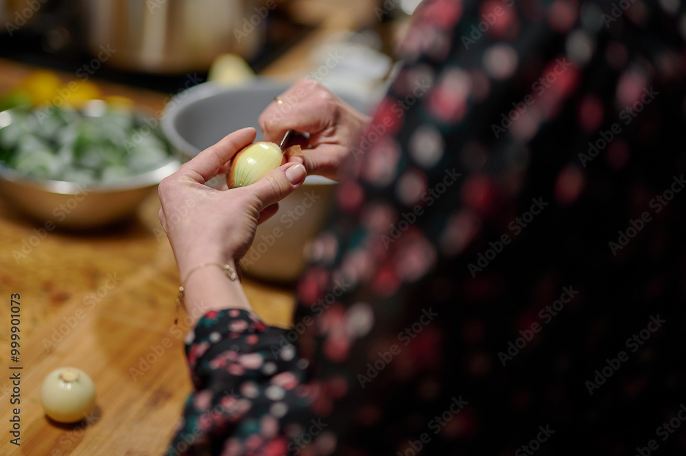 Culinary Prep: Hands Peeling Pearl Onions in a Warmly Lit Kitchen, Capturing the Art of Cooking