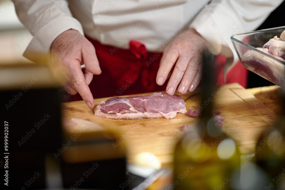 A Close-up of Skillful Meat Preparation in Warm Ambient Light, Captured in a Professional Kitchen Setting