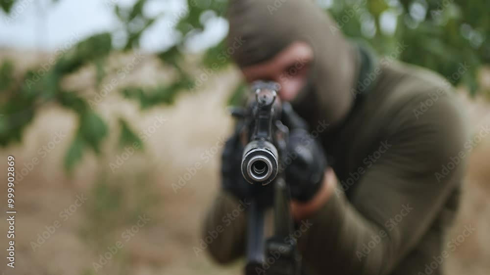 A professional soldier aims his machine gun at the enemy.