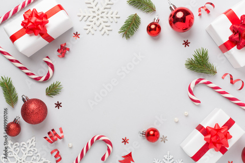 Christmas decor, gift boxes and confetti on color background, top view. Copy space for design