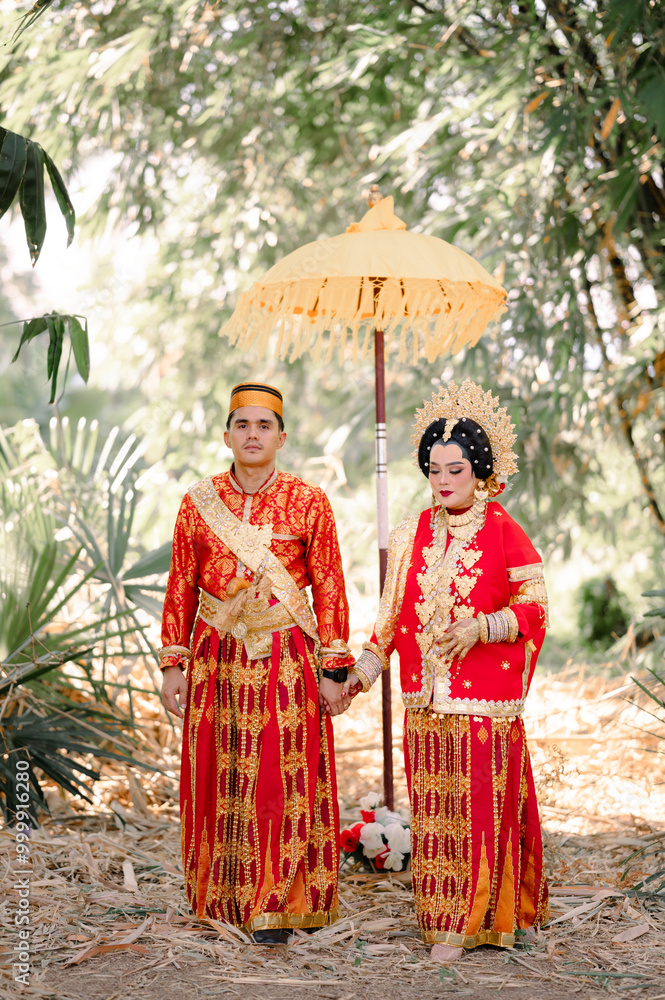 Fototapeta premium Asian Indonesian Couple Wearing Traditional Bugis Clothing, Pinrang South Sulawesi. Indonesia