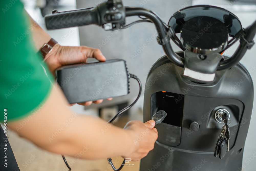 close up view of asian man hand taking off electric bicycle charger close up view of asian man hand taking off electric bicycle charger