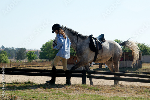 Teenage girl walking her horse before a competition, Johannesburg, Gauteng, South Africa photo