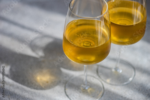 Close-up of two glasses of Traditional Georgian Kisi white wine on a table in sunlight photo