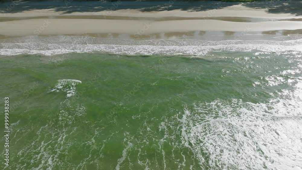 Aerial View of Waves Crashing on a Sunny Beach With Clear Turquoise Water in Florida During Midday Aerial View of Waves Crashing on a Sunny Beach With Clear Turquoise Water in Florida During Midday