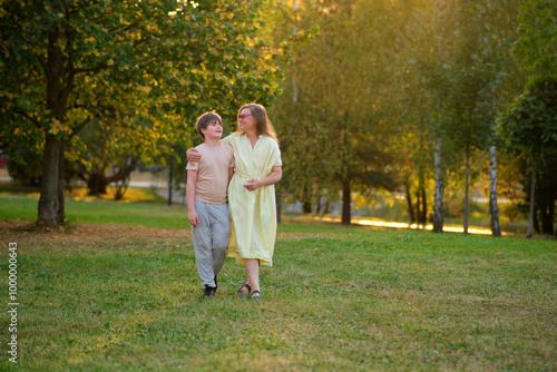 A portrait of a loving mother and her son spending quality time together in the beauty of nature. Capturing a beautiful day outdoors, a happy mother and her child smile brightly in the park.