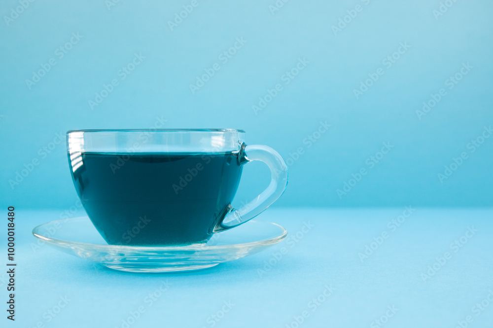 Anchan or Butterfly pea tea - cup of blue tea on blue background with copy space Anchan or Butterfly pea tea - cup of blue tea on blue background with copy space