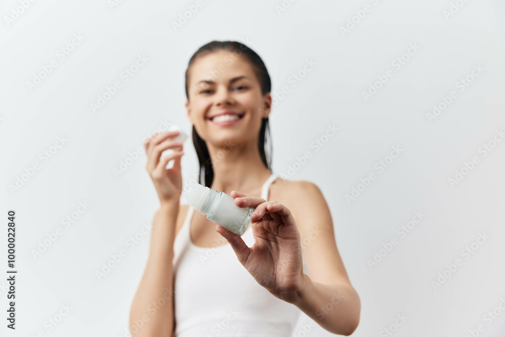 Deodorant close-up of a woman pointing at the camera and smiling Deodorant close-up of a woman pointing at the camera and smiling