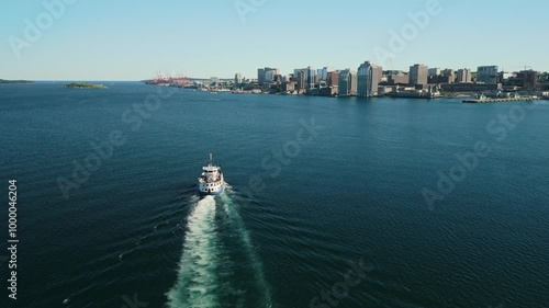 Watch As The Halifax Ferry Glides Across The Water With The City Skyline And Harborfront Of Halifax Creating A Stunning Scene. The Oldest Ferry Route In North America. Halifax, Nova Scotia, Canada 