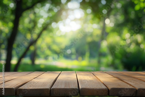 Empty wooden table top with a blurred green park background for product display montage, a summer concept. 