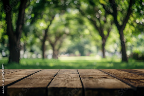 Empty wooden table top with a blurred green park background for product display montage, a summer concept. 