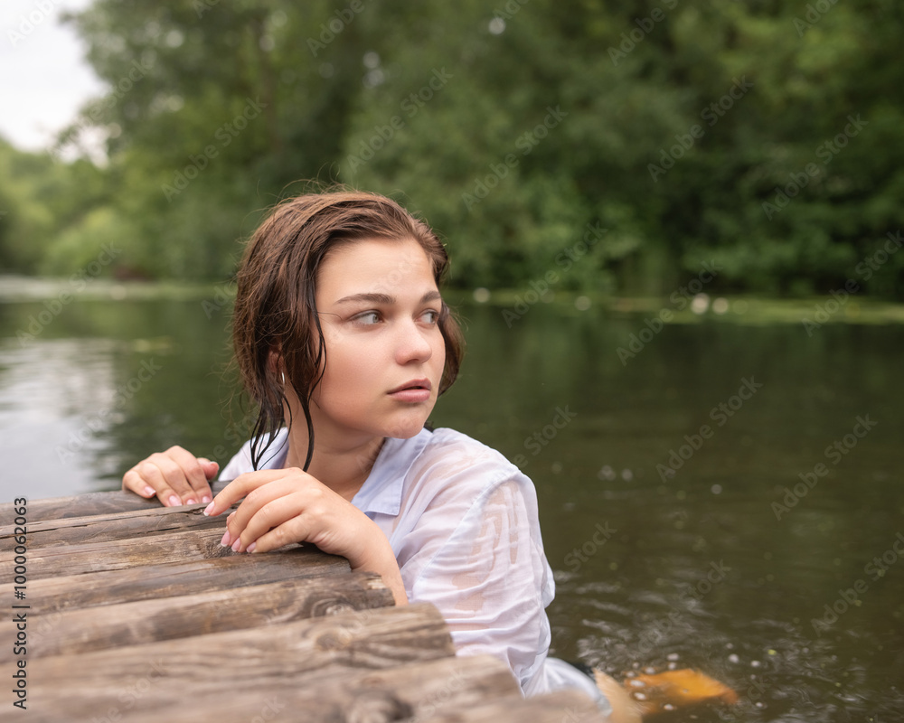 Beautiful young dark-haired girl by the river. Beautiful young dark-haired girl by the river.