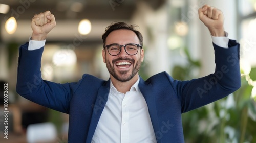 A man celebrating his success at a modern office during a bright afternoon