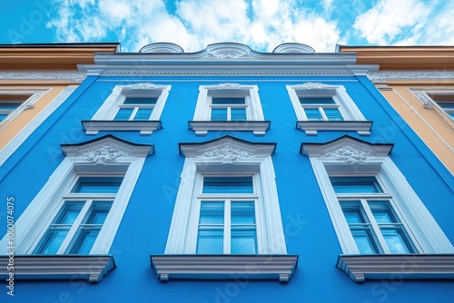 Charming Blue and White Building Adorned with Abundant Windows