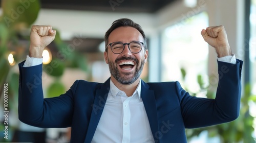 A man celebrating his success at a modern office during a bright afternoon