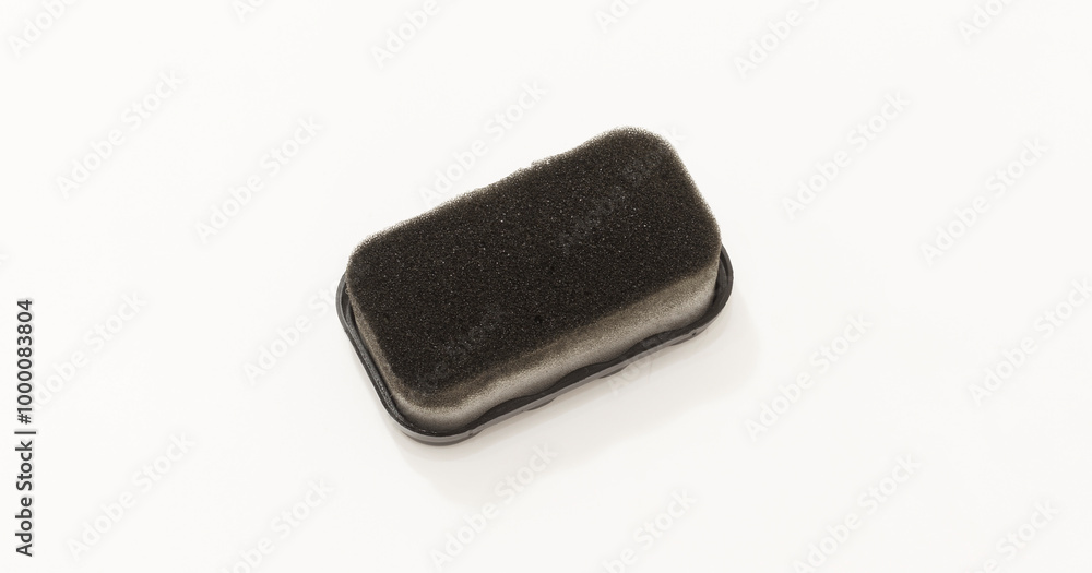 Short Rectangular foam sponge with black surface, commonly used for shoe polish or cleaning. Short Rectangular foam sponge with black surface, commonly used for shoe polish or cleaning.