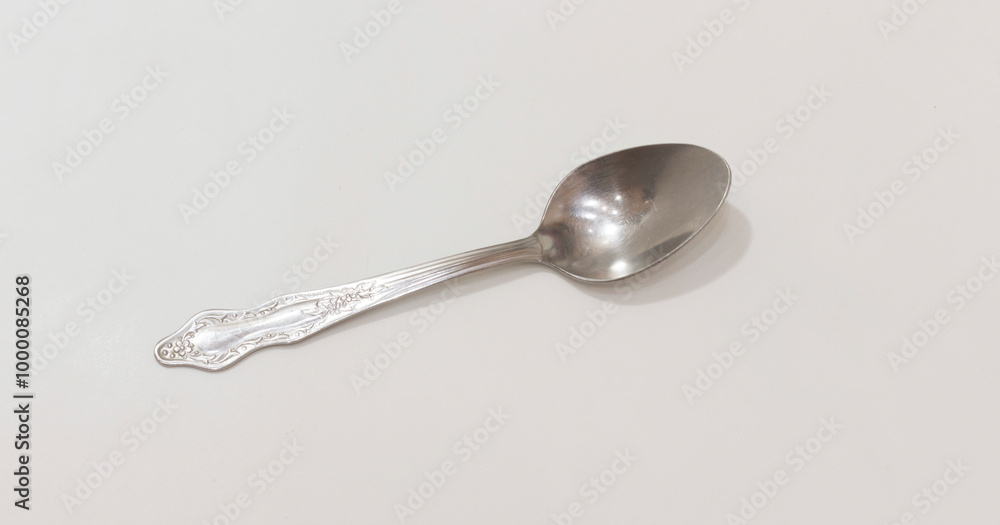 Elegant silver spoon with intricate floral design, suitable for classic table settings or vintage decor themes. Elegant silver spoon with intricate floral design, suitable for classic table settings or vintage decor themes.