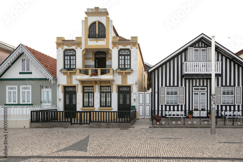 Portuguese tourist street with its emblematic striped and colorful houses. End of the day. Costa Nova do Prado, Aveiro, Portugal - August  2024