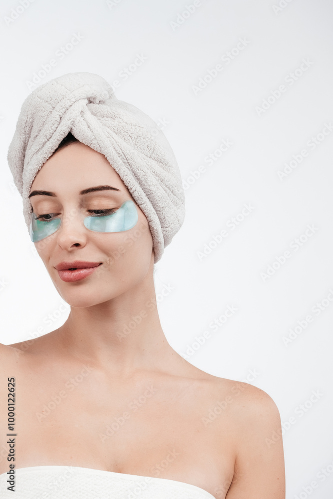 Close up of caucasian girl with natural no makeup, wears silicone under eye patches and smiling happy, using skincare products from dark circles, white background Close up of caucasian girl with natural no makeup, wears silicone under eye patches and smiling happy, using skincare products from dark circles, white background