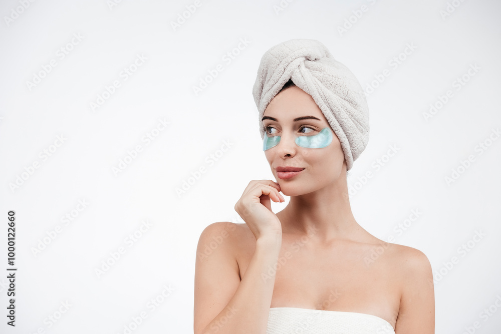 Close up of caucasian girl with natural no makeup, wears silicone under eye patches and smiling happy, using skincare products from dark circles, white background Close up of caucasian girl with natural no makeup, wears silicone under eye patches and smiling happy, using skincare products from dark circles, white background