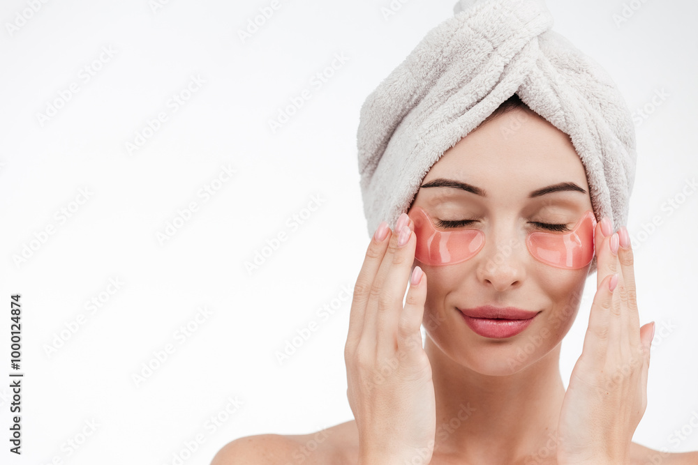 Eye patches, patch under eyes. smiling young girl has collagen golden eye patches on face with towel. Beautiful woman isolated face portrait, banner with mock up copy space Eye patches, patch under eyes. smiling young girl has collagen golden eye patches on face with towel. Beautiful woman isolated face portrait, banner with mock up copy space