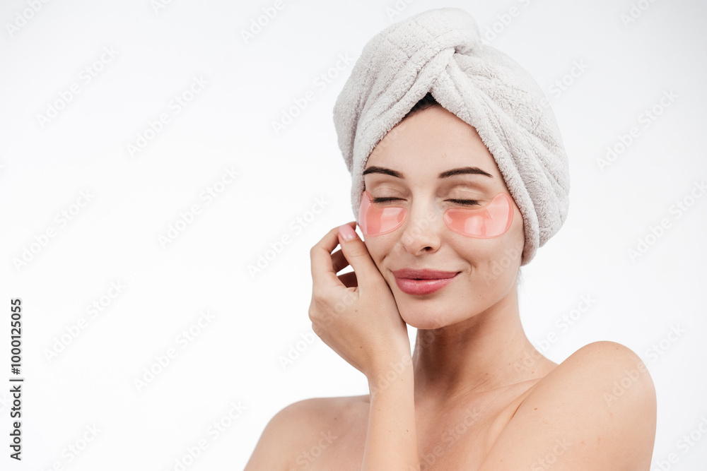 Eye patches, patch under eyes. smiling young girl has collagen golden eye patches on face with towel. Beautiful woman isolated face portrait, banner with mock up copy space Eye patches, patch under eyes. smiling young girl has collagen golden eye patches on face with towel. Beautiful woman isolated face portrait, banner with mock up copy space