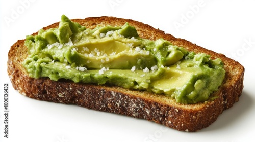 A close-up of a slice of golden-brown toast topped with creamy avocado and a sprinkle of salt, set against a bright white background, highlighting a healthy breakfast option.