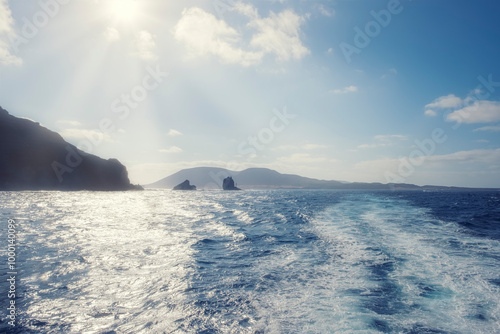 Punta Fariones with the island of La Graciosa in the background backlit by volcanic cliffs on the island of Lanzarote