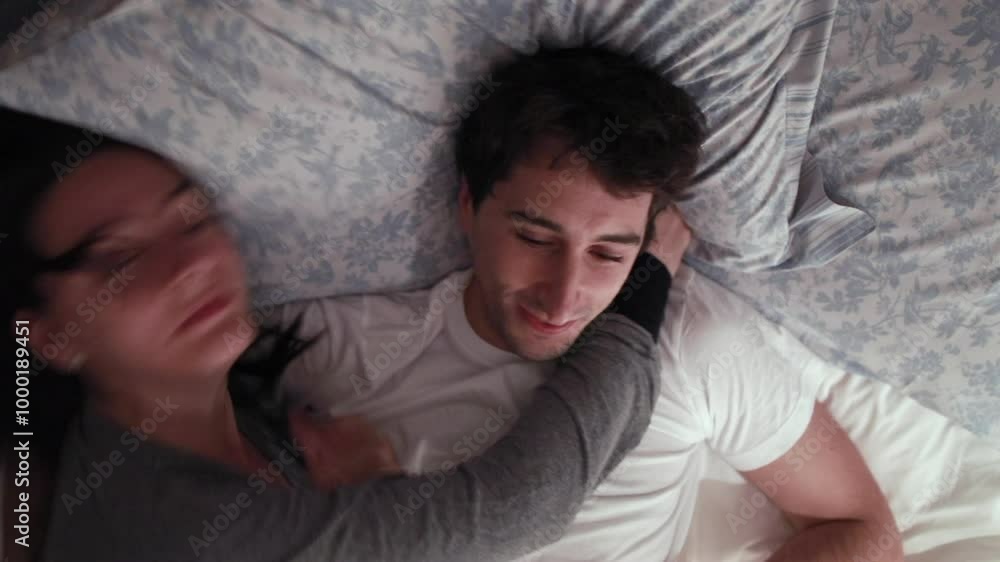 Woman kisses man on the cheek while embracing him in bed. Calmness and love highlight an intimate moment of affection and warmth in a cozy bedroom setting Woman kisses man on the cheek while embracing him in bed. Calmness and love highlight an intimate moment of affection and warmth in a cozy bedroom setting