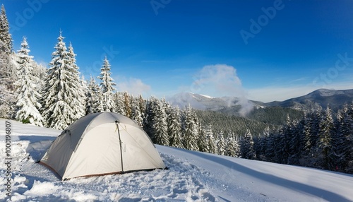 camping in winter in the mountains. tent in idyllic winter landscape in the mountains