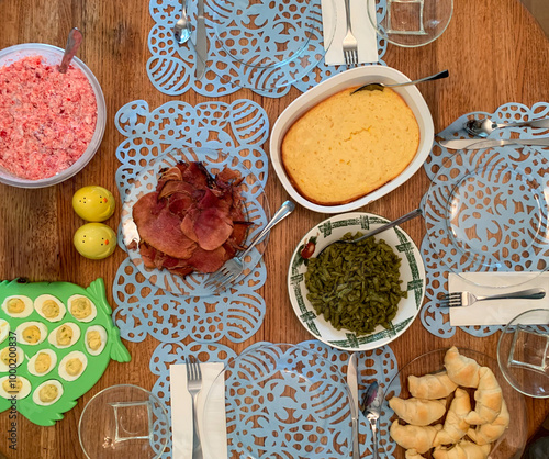 Classic American Easter Dinner With Ham, Green Beans, Corn Spoon bread, Jello, Deviled Eggs, And Crescent Rolls photo