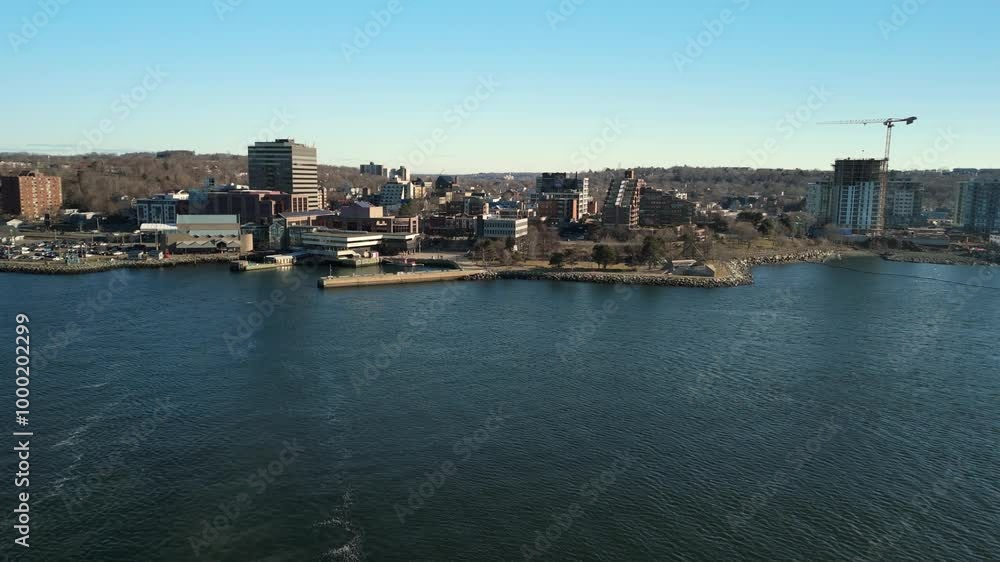 A Serene Aerial Shot Of Downtown Dartmouth At Sunset, With The Bay And Halifax Skyscrapers Glowing In The Soft Light Of A Warm Summer Evening. Nova Scotia, Canada. A Serene Aerial Shot Of Downtown Dartmouth At Sunset, With The Bay And Halifax Skyscrapers Glowing In The Soft Light Of A Warm Summer Evening. Nova Scotia, Canada.