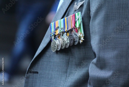 Sydney, NSW Australia - April 25 2021: Anzac Day March. A man in a grey suit wearing medals and rosemary