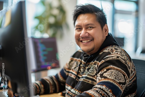 Cheerful Indigenous programmer man working with computers in office. , background blur
