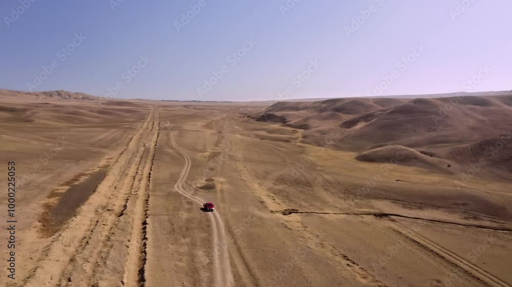 Experience the mesmerizing sight of an offroad car cruising through the vast desert landscape of the Georgia mountains. Experience the mesmerizing sight of an offroad car cruising through the vast desert landscape of the Georgia mountains.