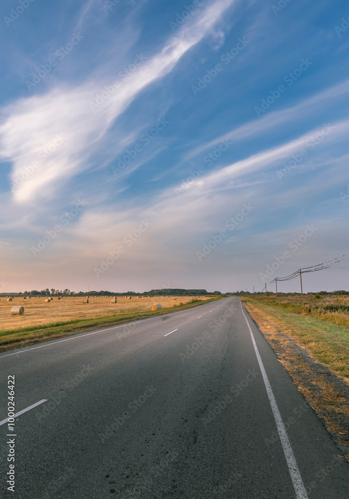 Naklejka premium A long road with a clear blue sky above it