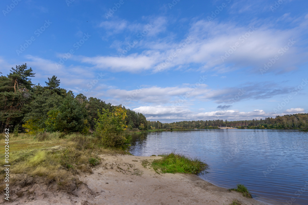 A beautiful lake with a clear blue sky above it A beautiful lake with a clear blue sky above it