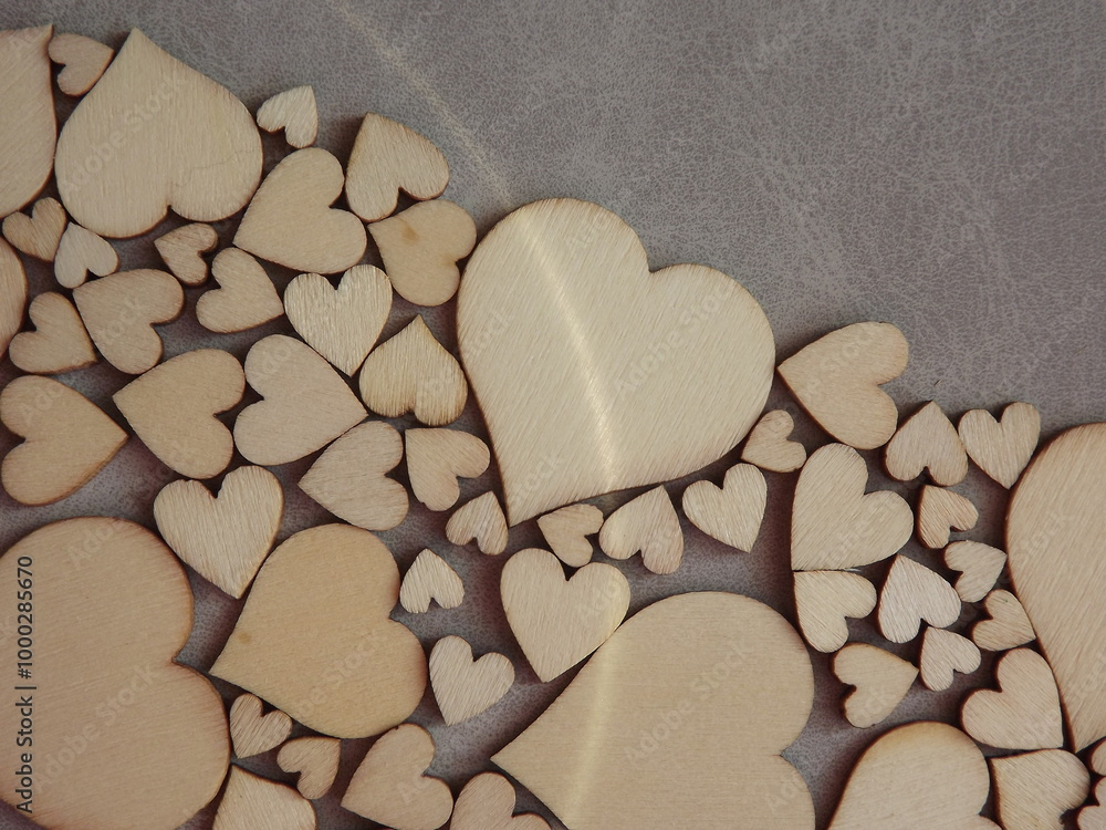 Obraz premium valentine's day greeting card-wooden hearts on a gray suede background. High quality photo