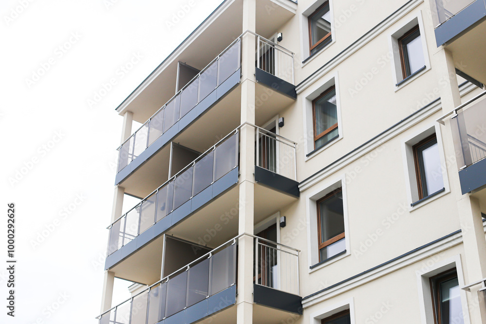 Newly constructed apartment block. Modern building with multiple balconies. Real estate opportunity for apartment purchase. Contemporary design, new residential development. Block of flats cityscape. Newly constructed apartment block. Modern building with multiple balconies. Real estate opportunity for apartment purchase. Contemporary design, new residential development. Block of flats cityscape.